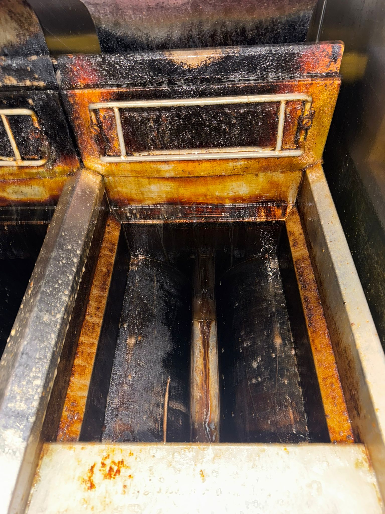 Fryer before cleaning - heavy grease buildup